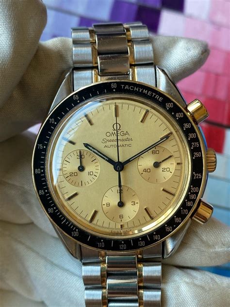 Omega Speedmaster SS/18K Yellow Gold Champagne Dial.